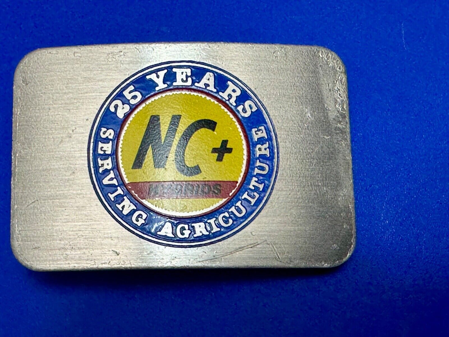 25 years serving agriculture - NC+ Hybrids Farmers Agriculture belt buckle