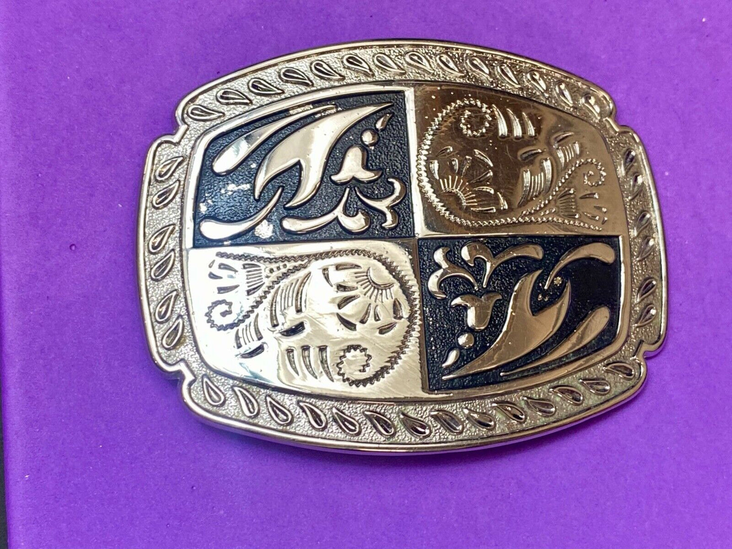 black and silver color western flower swirl outlined cowboy's belt buckle