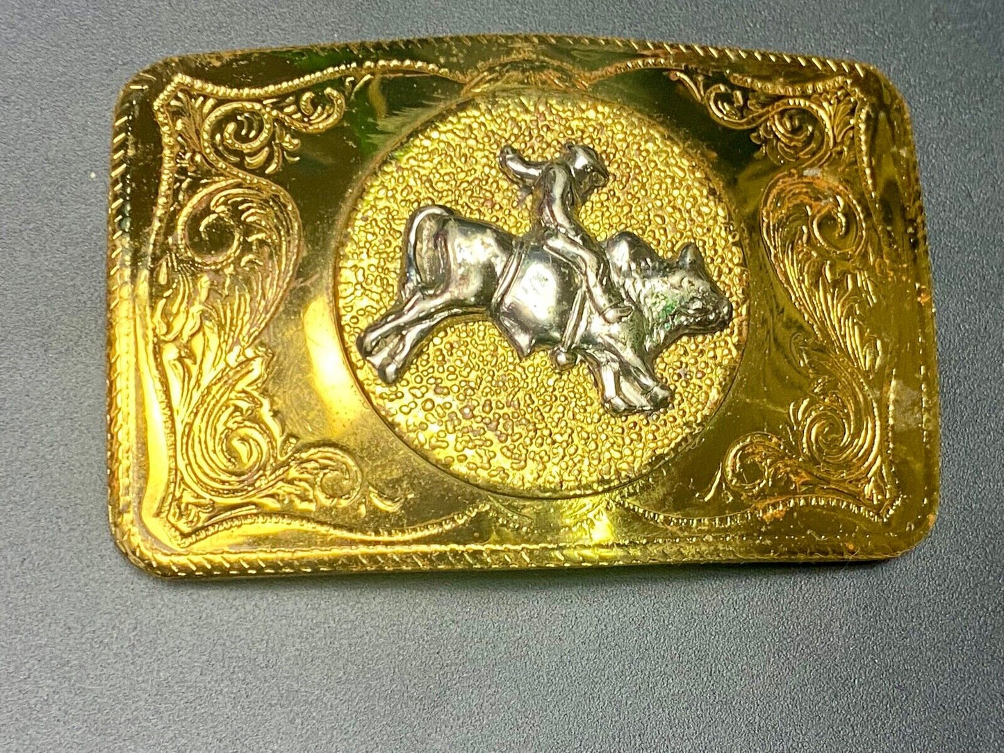 Beautiful ornate solid brass rodeo cowboy on rectangular western belt buckle