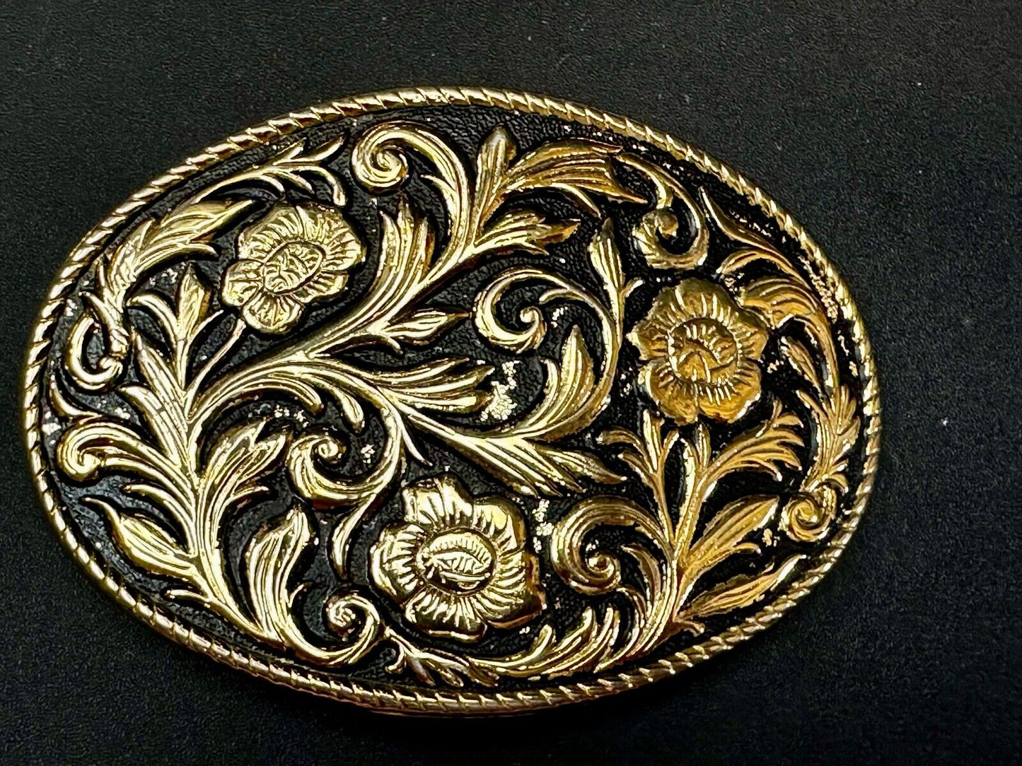 Vintage black and gold tone western flower floral theme cowboys belt buckle