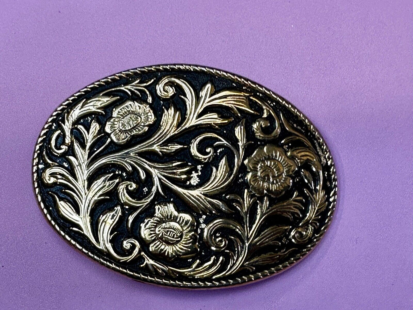 Vintage black and gold tone western flower floral theme cowboys belt buckle