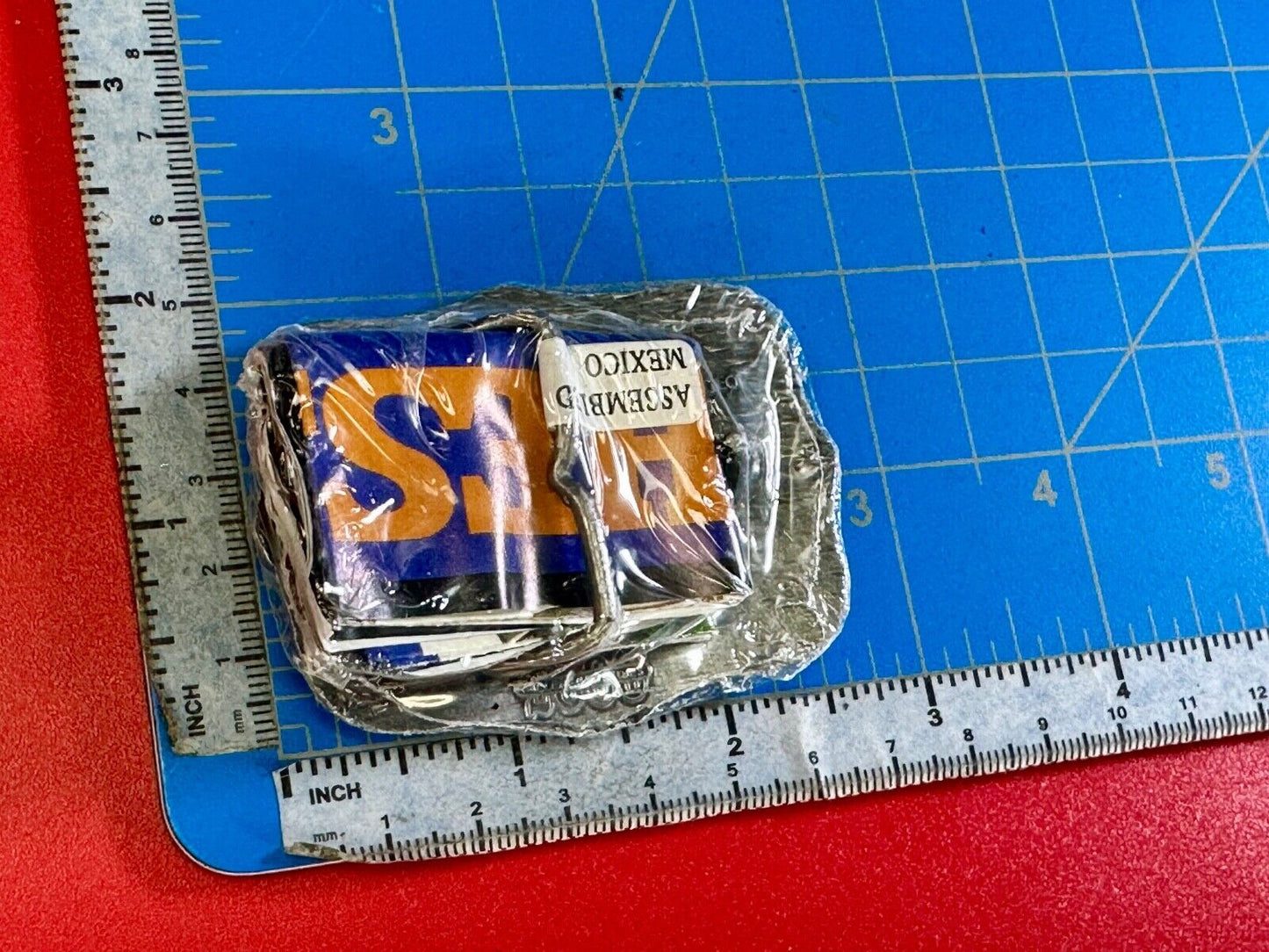 1999 Youth Sized Hesston National Finals Rodeo 2000 series belt buckle in wrap