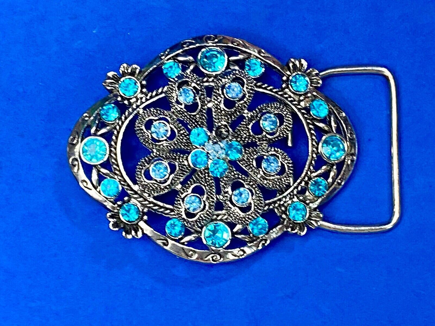 BEAUTIFUL BLUE rhinestones mounted in oval shaped flower theme belt buckle