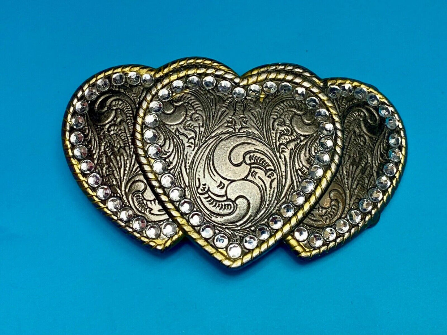Three hearts ornate flower swirl belt buckle with thick rhinestone boarder