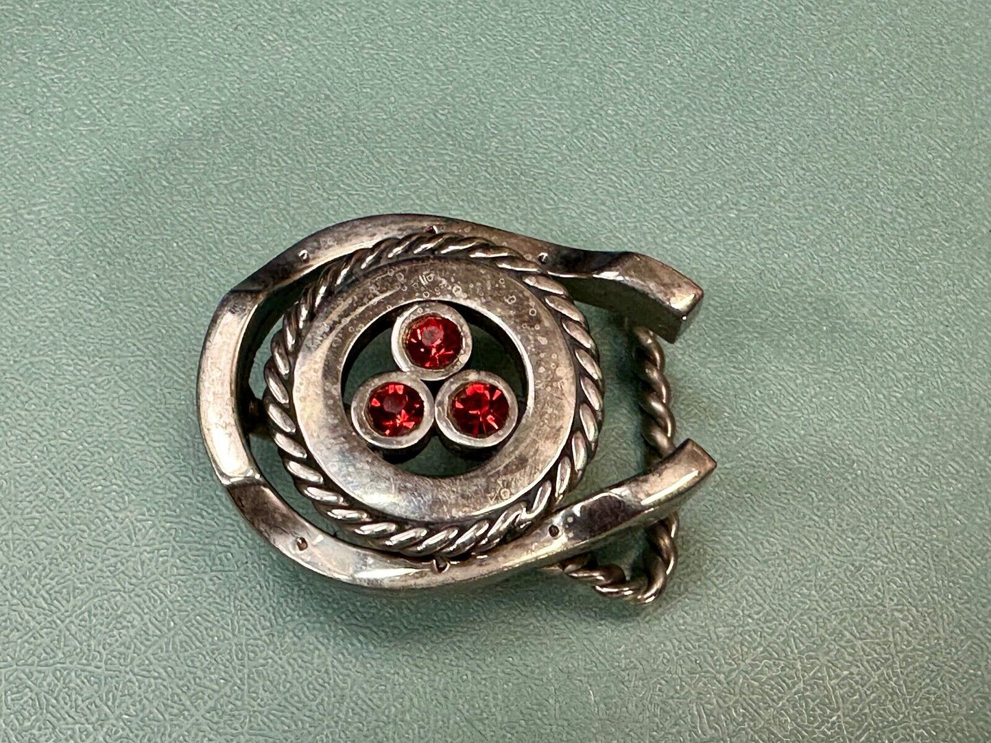 artisan circle pattern rope centerpiece red dots horseshoe shaped belt buckle