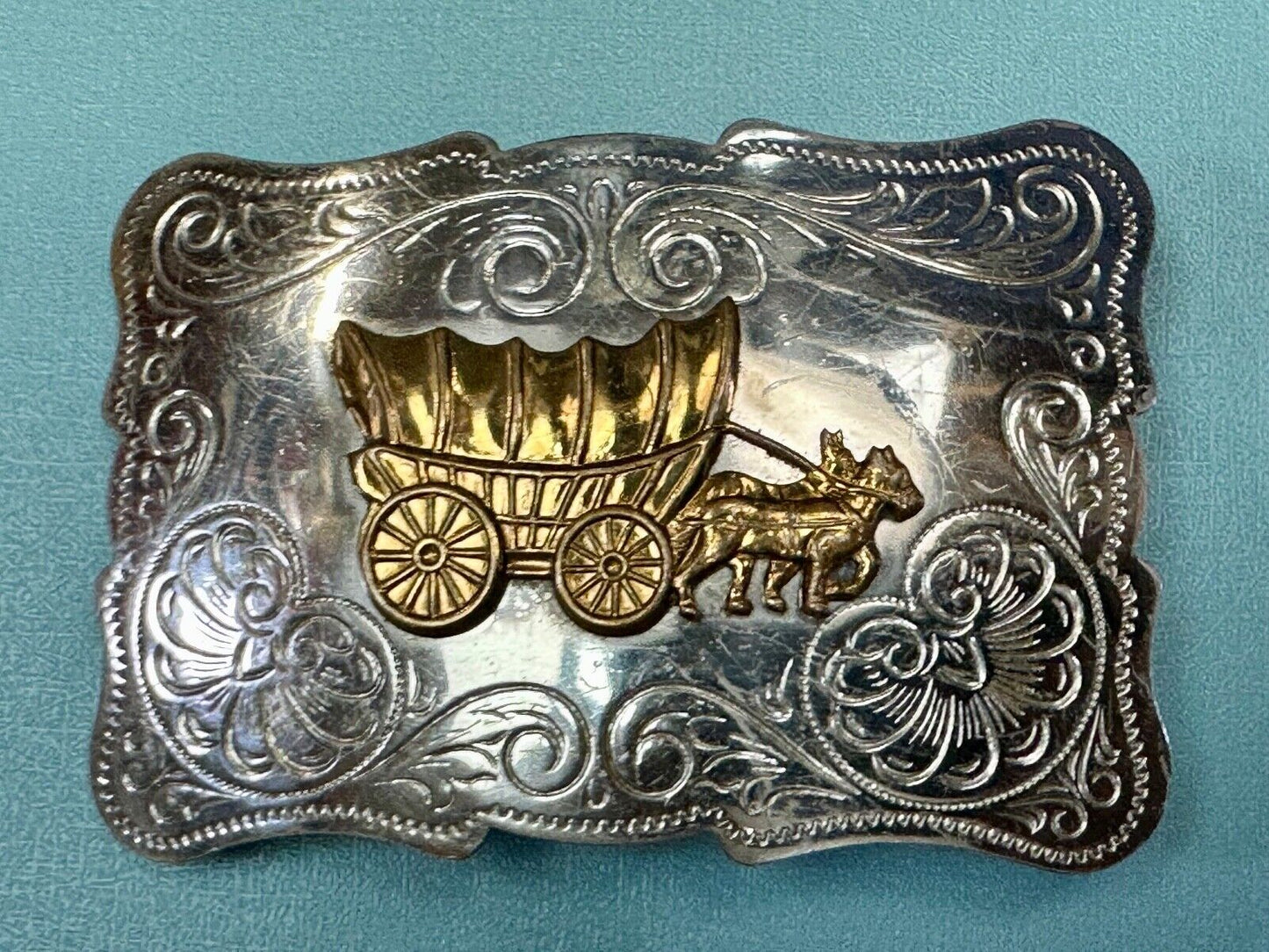Vintage Covered Wagon two tone ornate cowboys out west flower swirl belt buckle