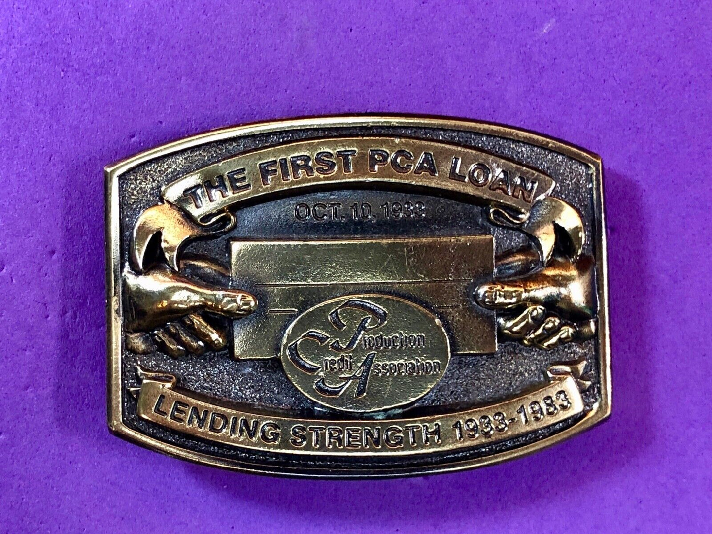 The first PCA loan belt buckle - Lending and strength production credit assn.