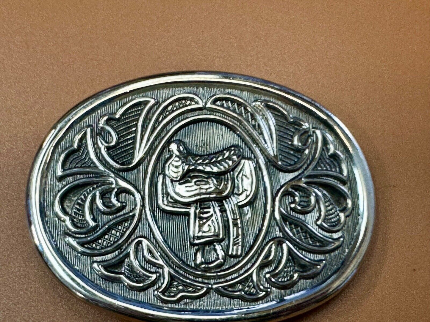 Vintage Cowboy's Horse Saddle ornate flower swirl oval belt buckle by Avon