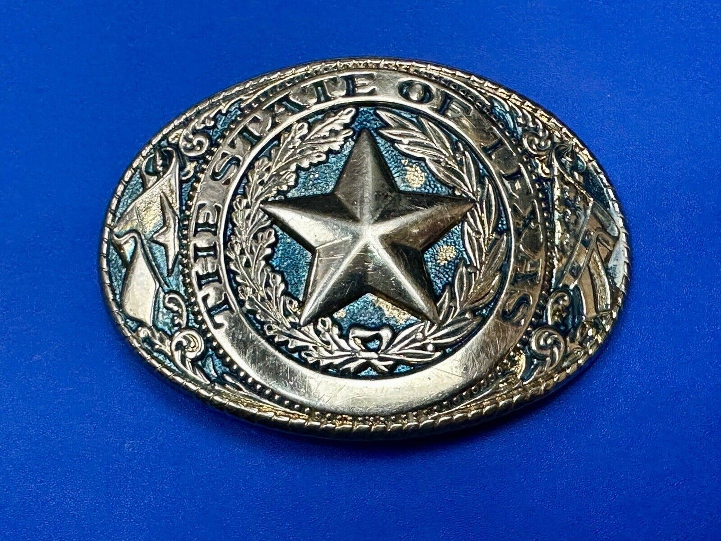 The Great State of Texas - gold color star belt buckle with blue colored accents