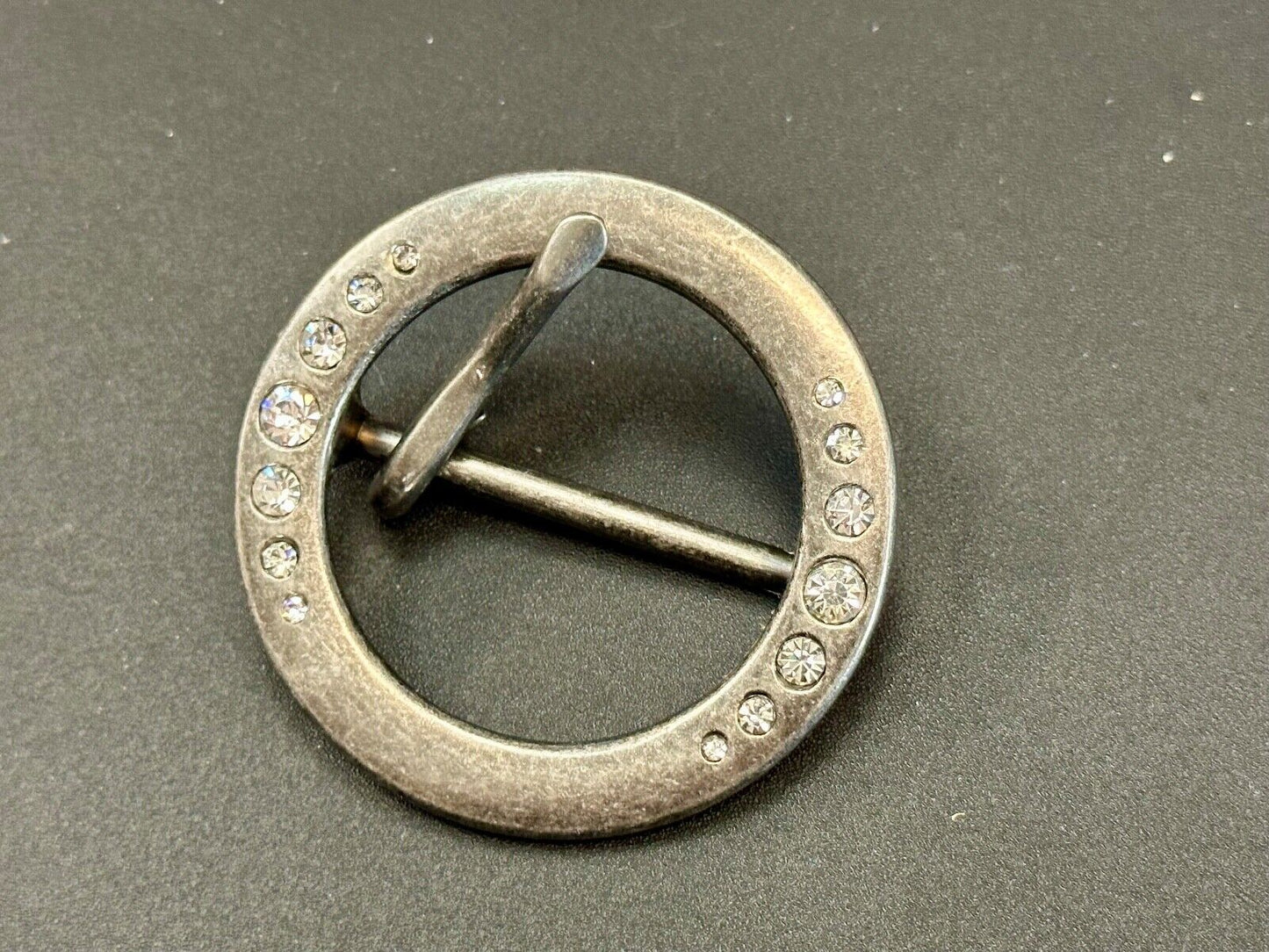 2" Round silver tone belt buckle with graduated rhinestone sized