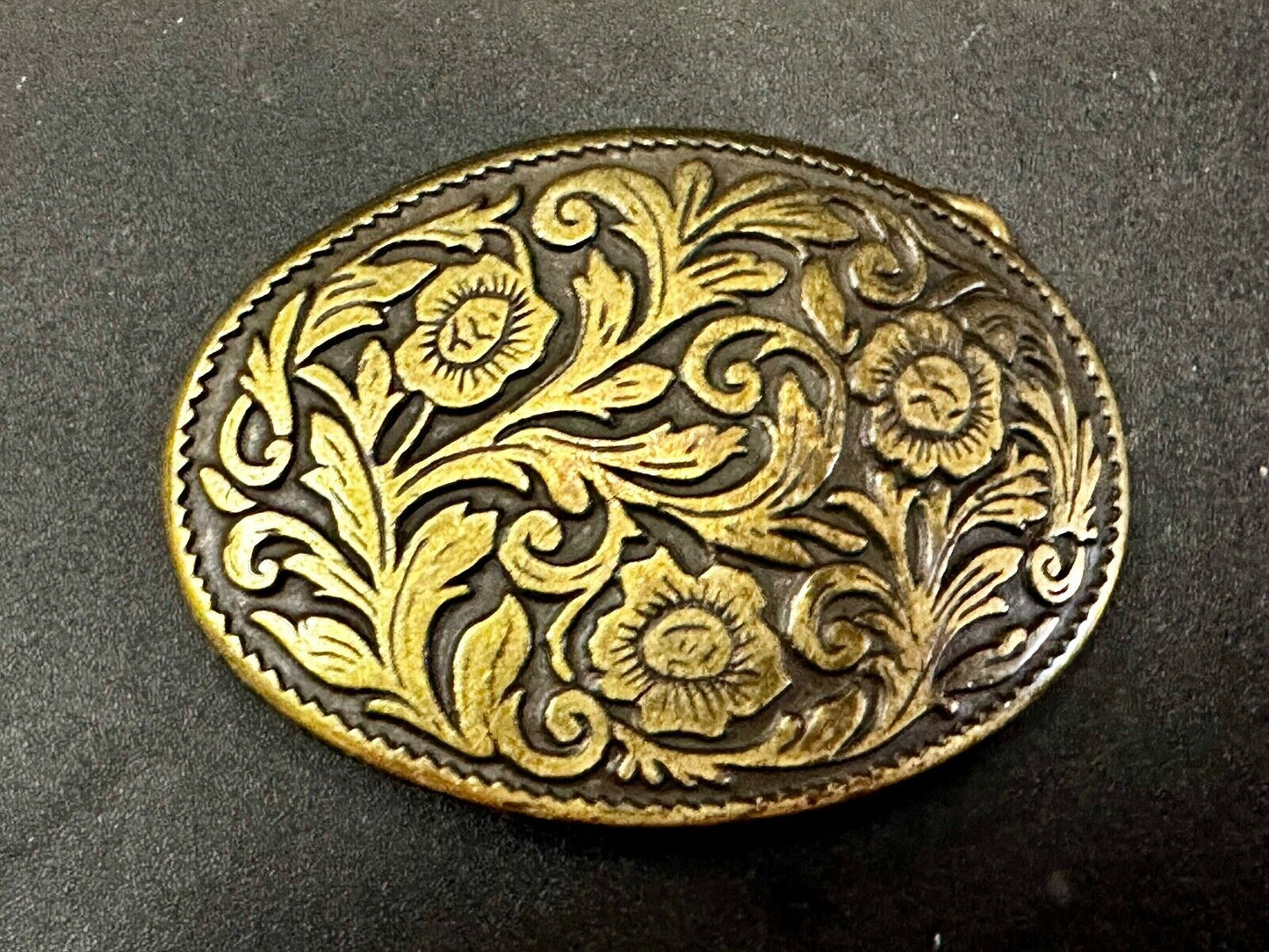 Vintage black and gold tone western flower floral theme cowboys belt buckle