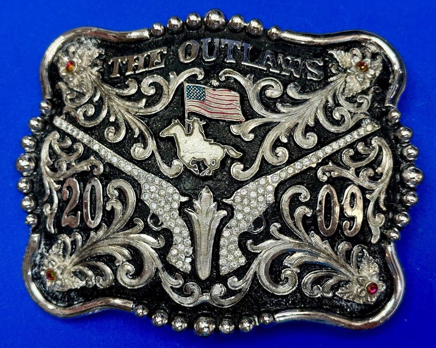 The Outlaws Rodeo Cowboy Trophy 2009 Flag Belt Buckle - Crossroads bucklesTexas