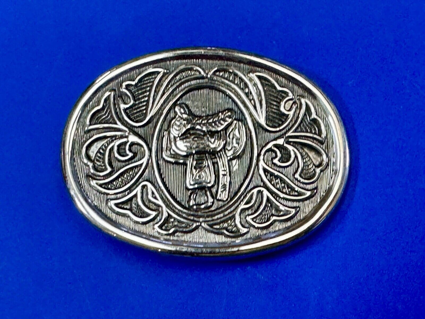 Vintage Cowboy's Horse Saddle ornate flower swirl oval belt buckle by Avon
