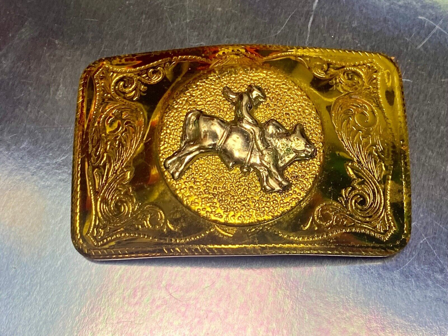 Beautiful ornate solid brass rodeo cowboy on rectangular western belt buckle