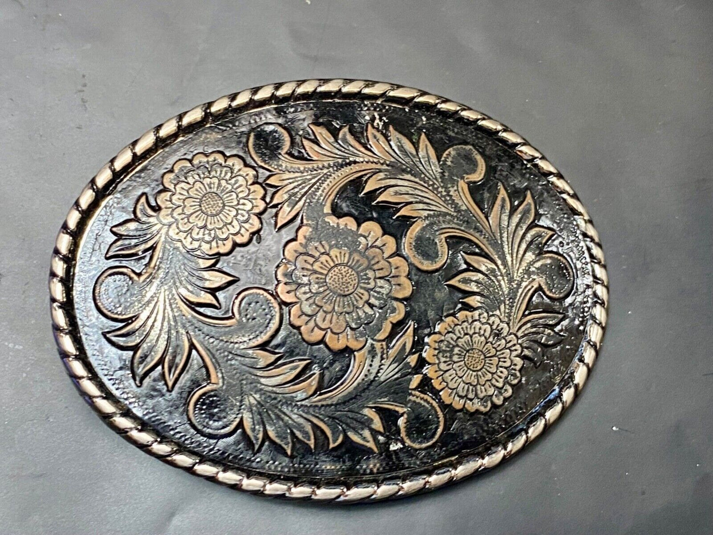 Beautiful flower design black & copper color oval outlined western belt buckle W