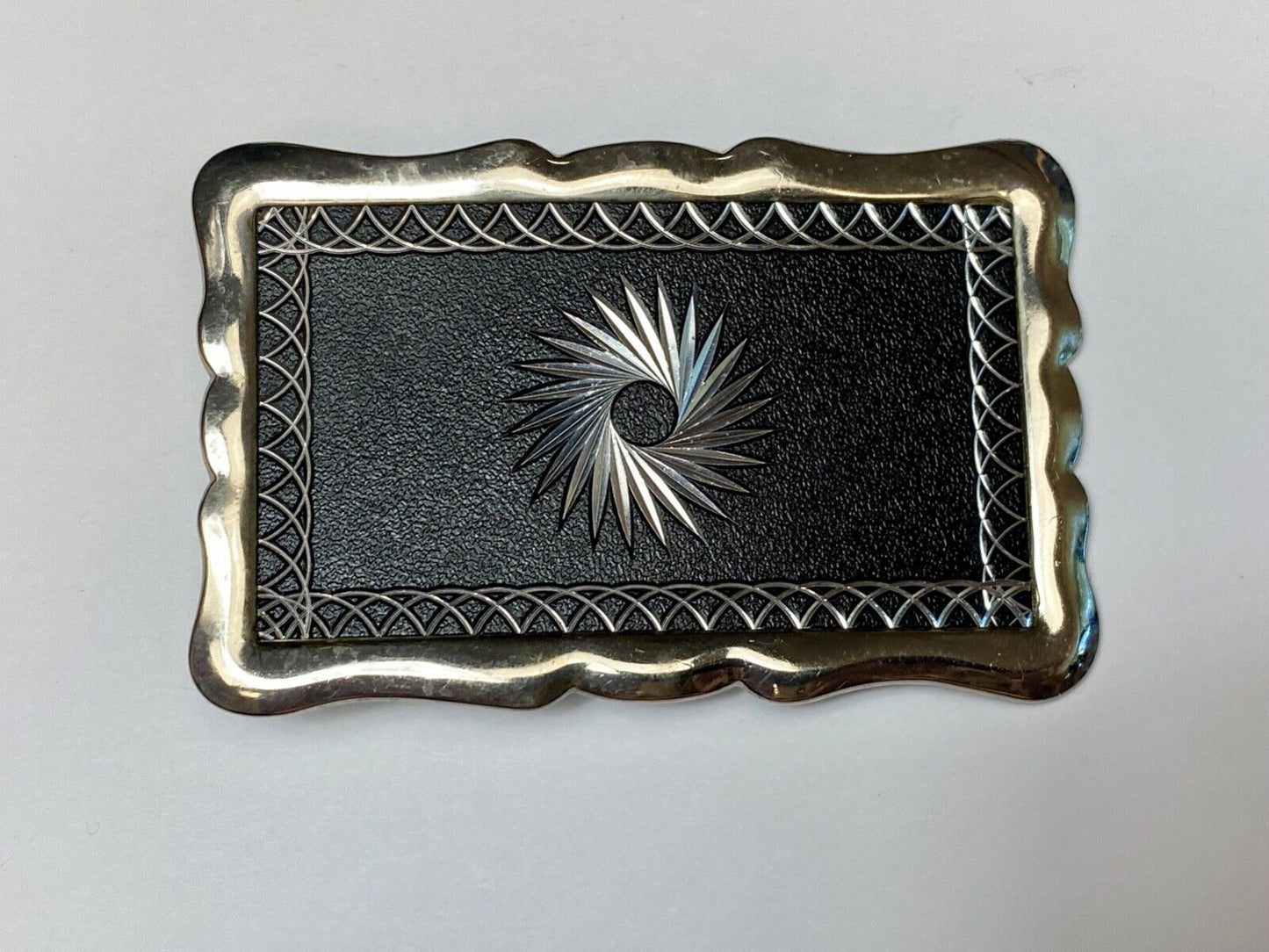 Black and silver color etched starburst pattern rectangular belt buckle
