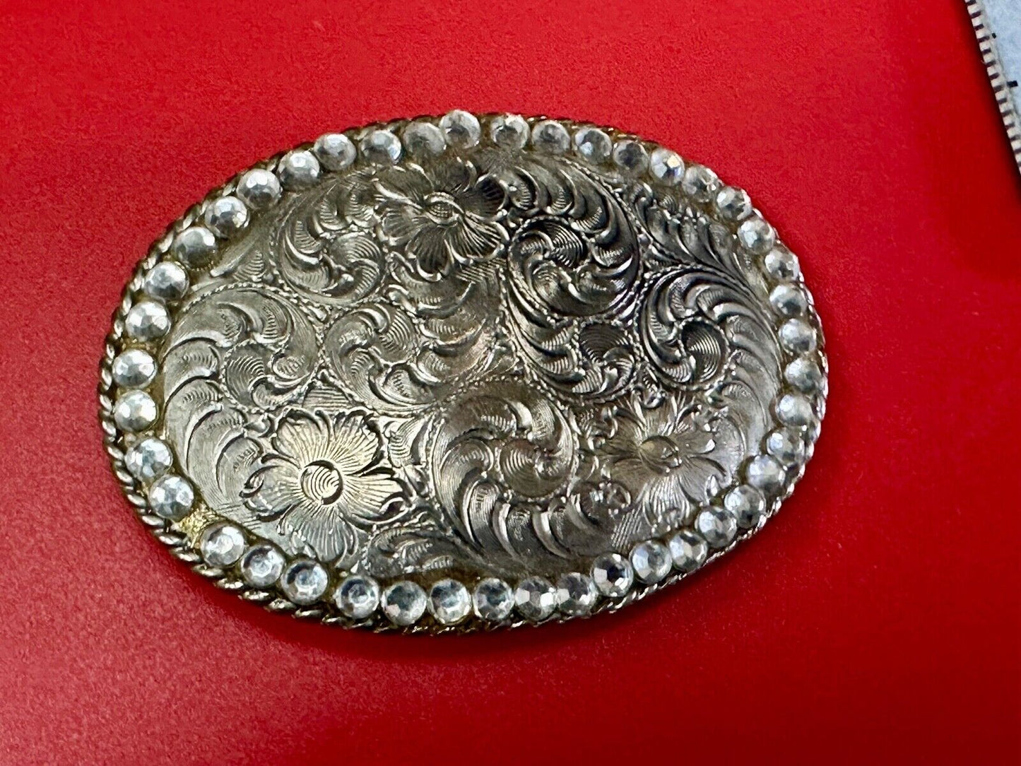 vintage 1996 western flower swirl oval belt buckle with rhinestone boarder