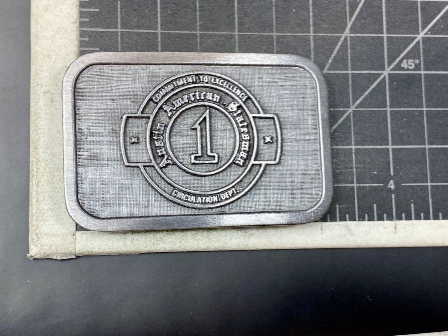 Asian American Circulation Dept Commitment to excellence belt buckle hit-line