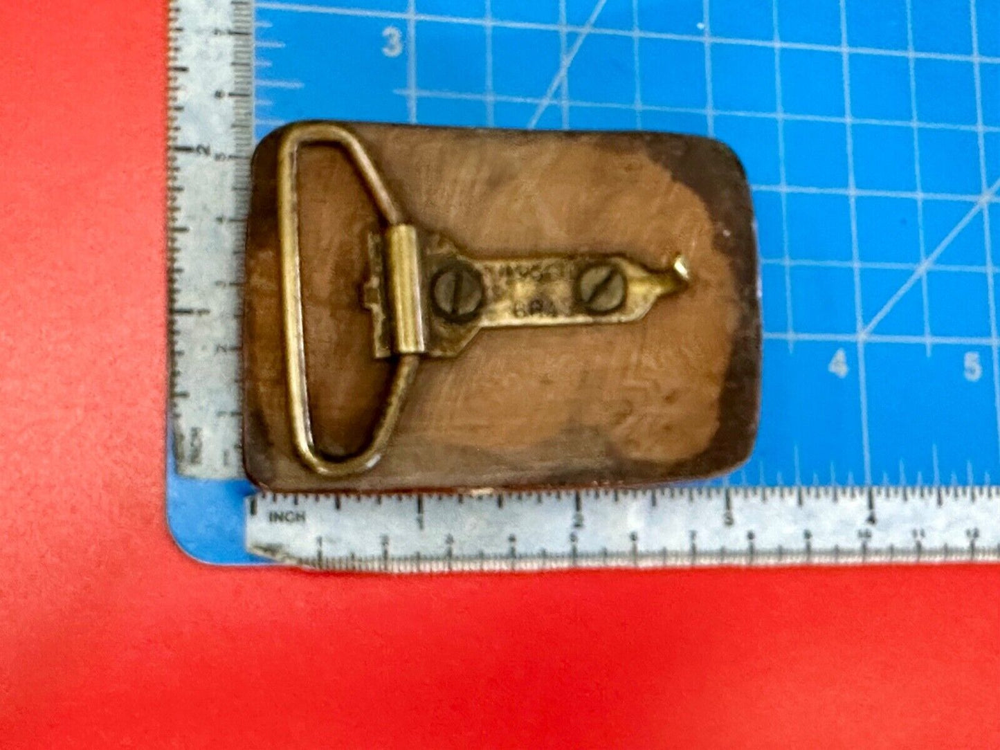 Artisan wooden glossy wood belt buckle with gold color artist scene?