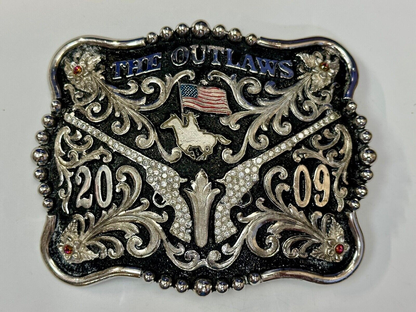 The Outlaws Rodeo Cowboy Trophy 2009 Flag Belt Buckle - Crossroads bucklesTexas