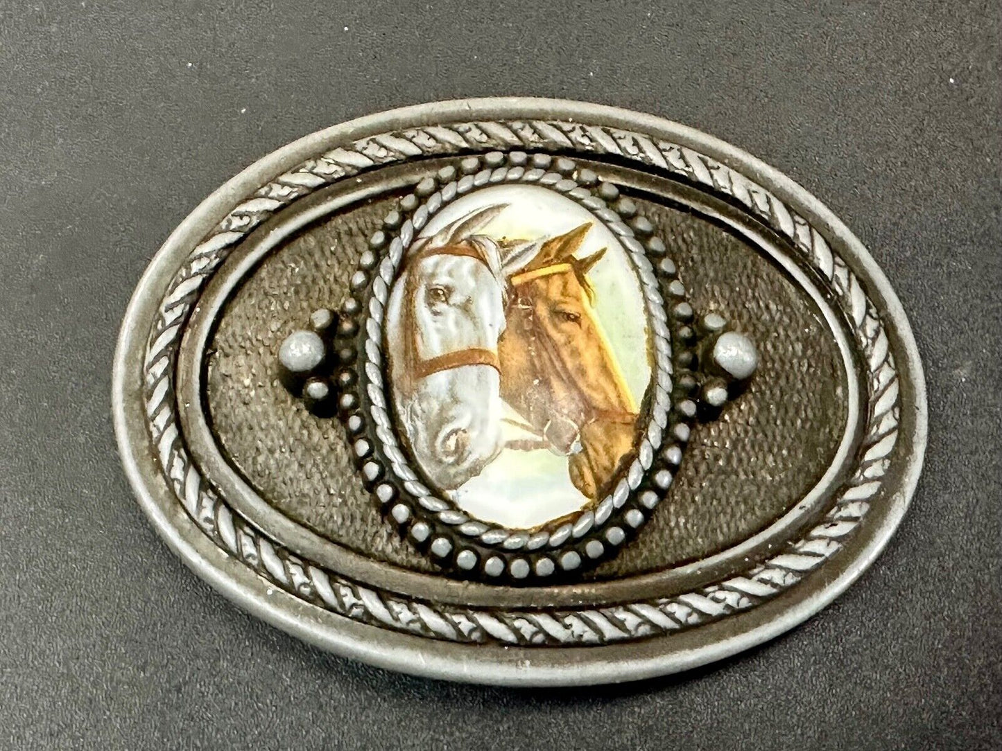 2 horses picture as centerpiece in western oval belt buckle with rope border