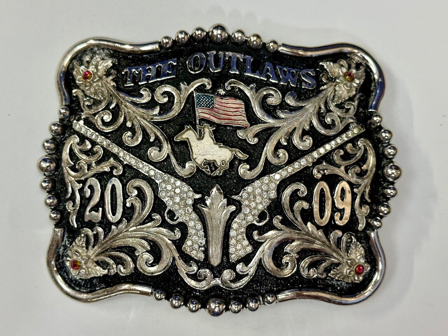 The Outlaws Rodeo Cowboy Trophy 2009 Flag Belt Buckle - Crossroads bucklesTexas