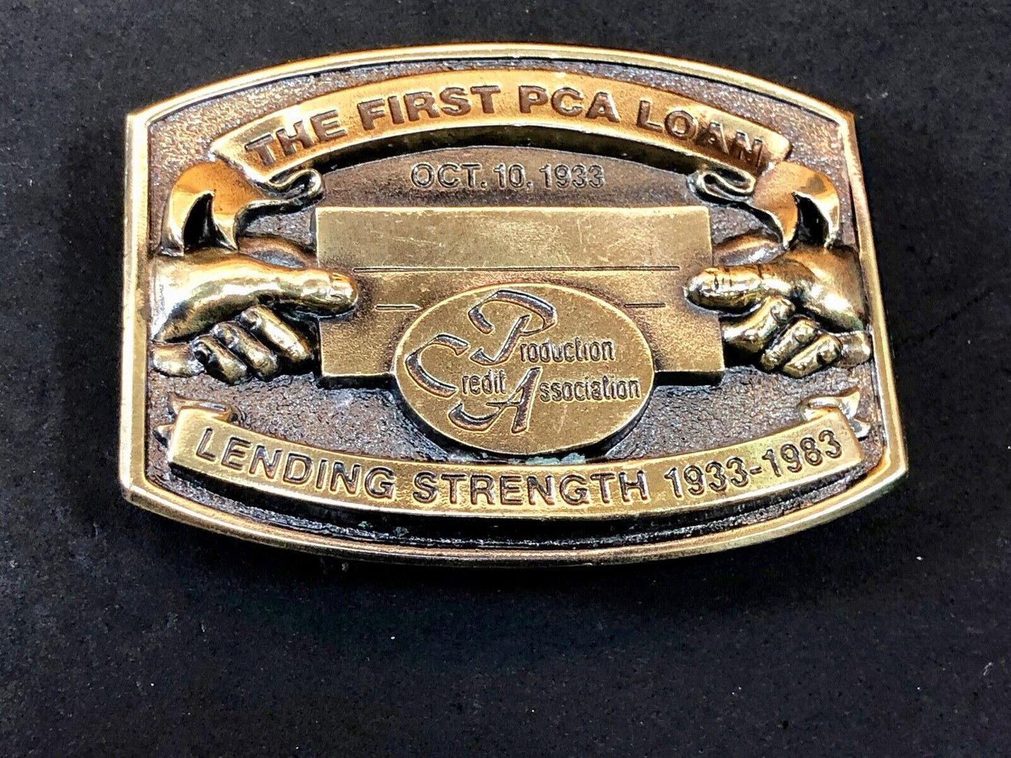 The first PCA loan belt buckle - Lending and strength production credit assn.