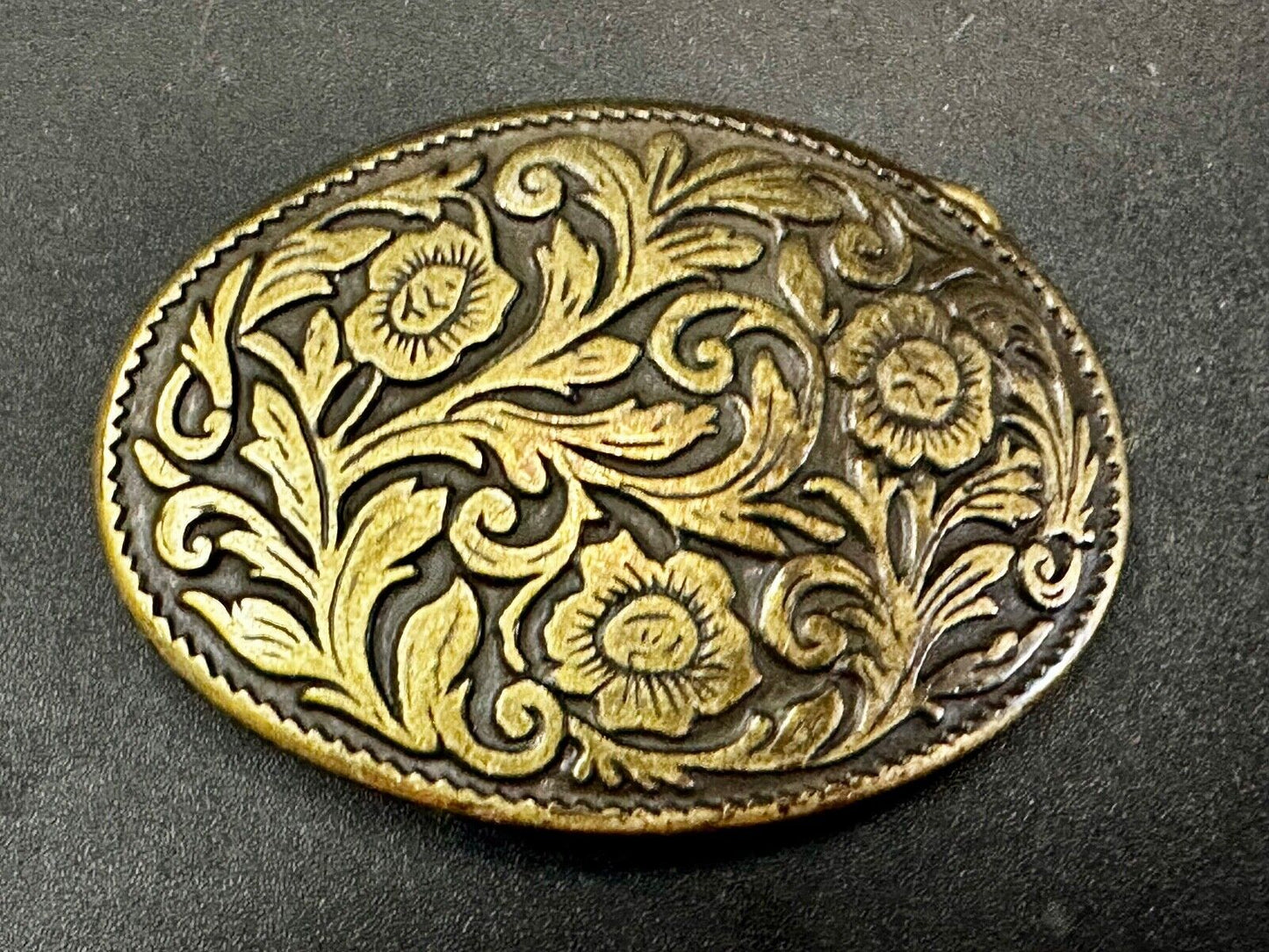 Vintage black and gold tone western flower floral theme cowboys belt buckle
