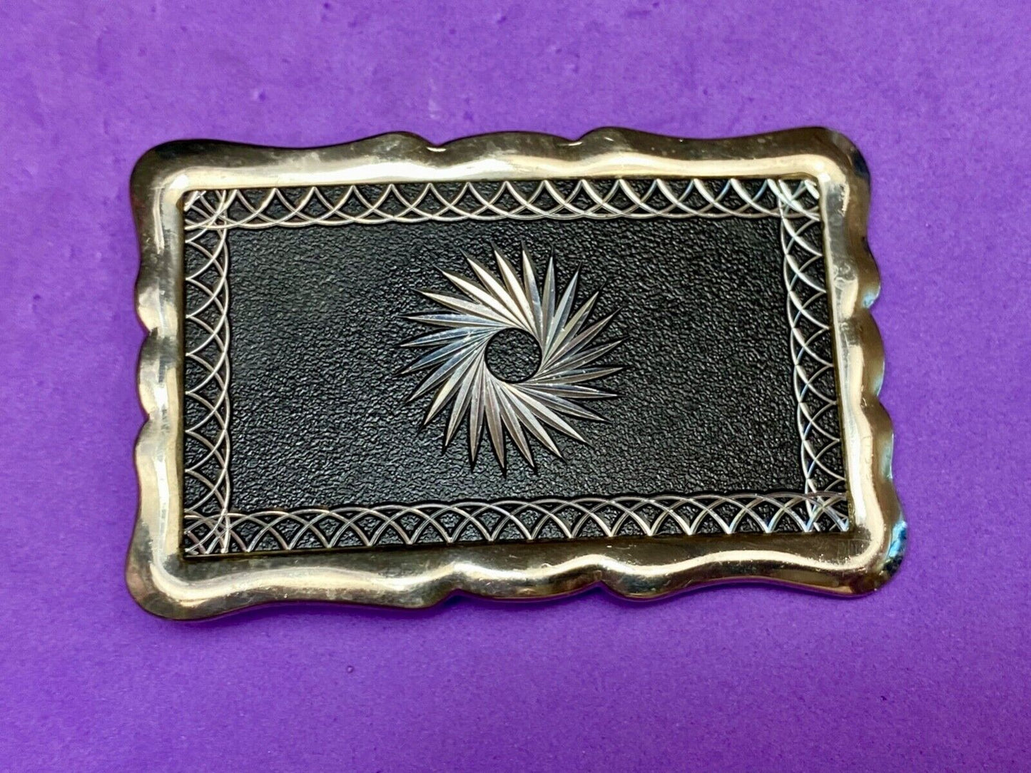Black and silver color etched starburst pattern rectangular belt buckle