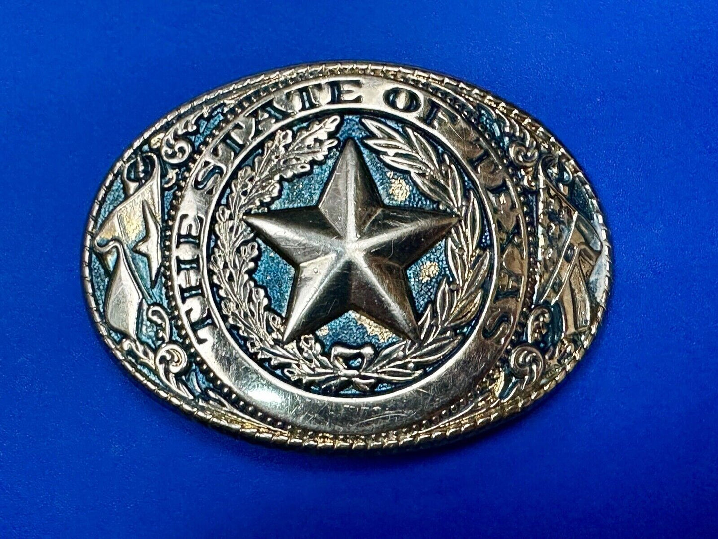 The Great State of Texas - gold color star belt buckle with blue colored accents