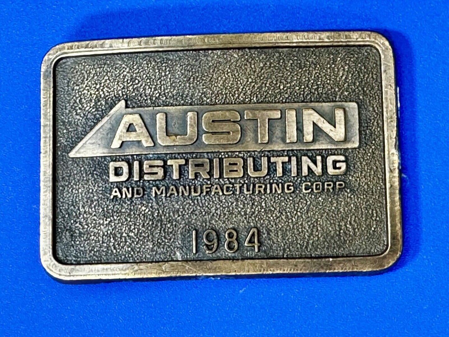 Austin Texas Distributing and Manufacturing 1984 Advertisement Promo Belt Buckle