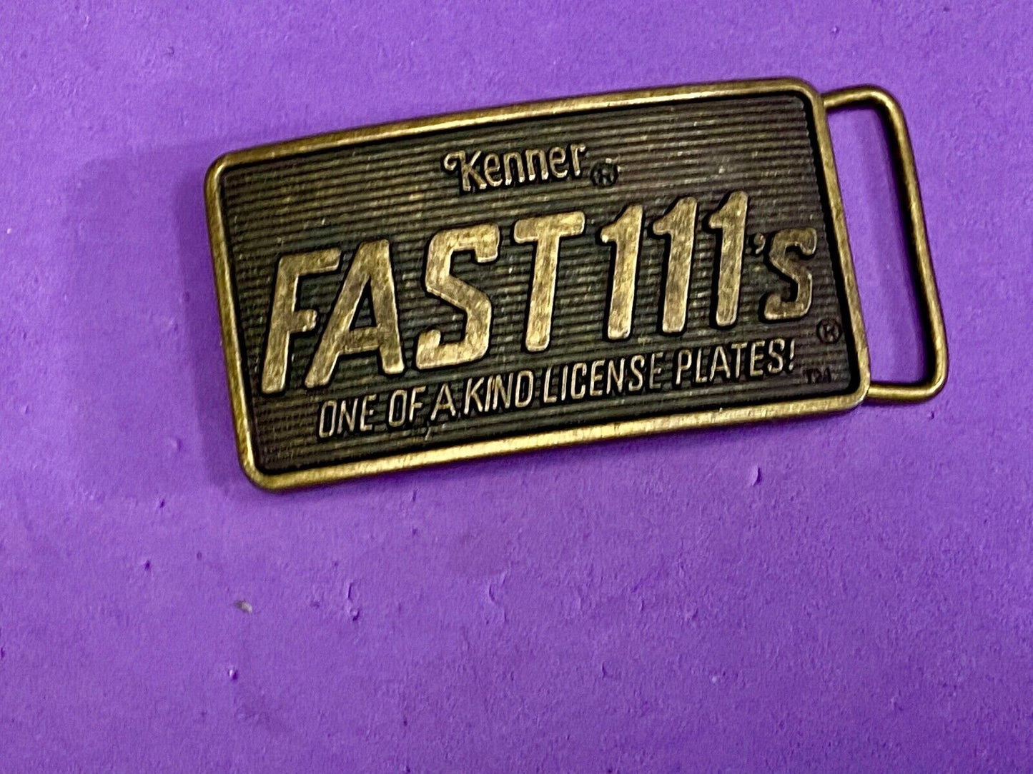 1982 Kenner Fast 111'S Company Advertisement Belt Buckle License Plates