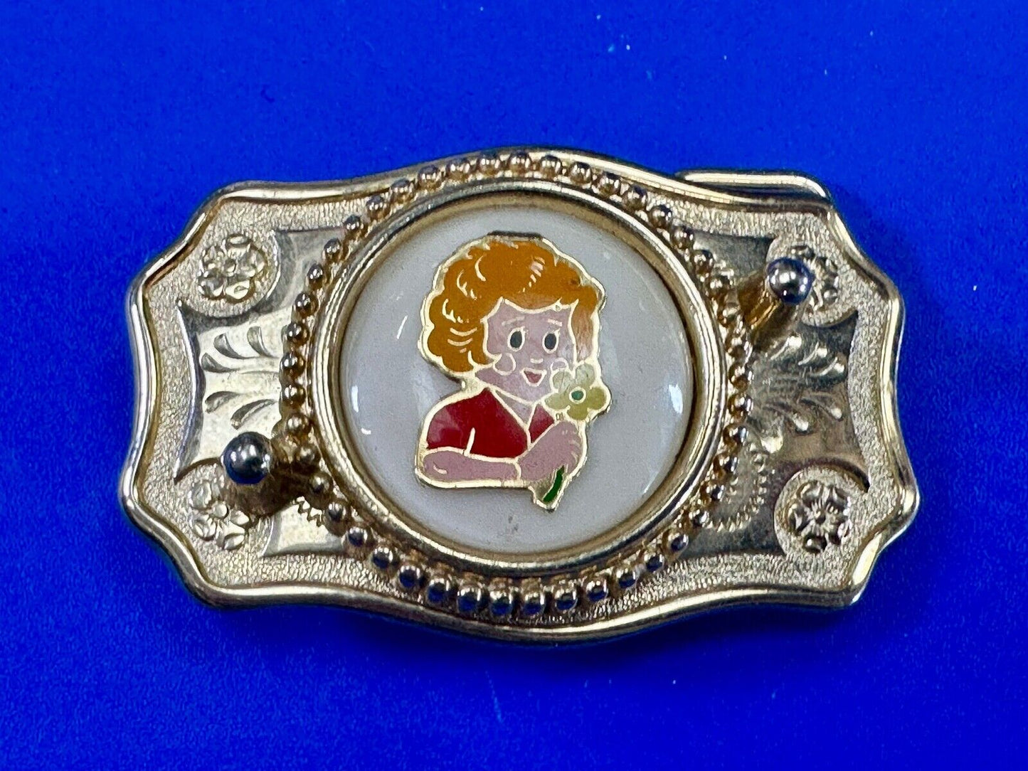 Adorable red headed girl with flower as centerpiece on western belt buckle