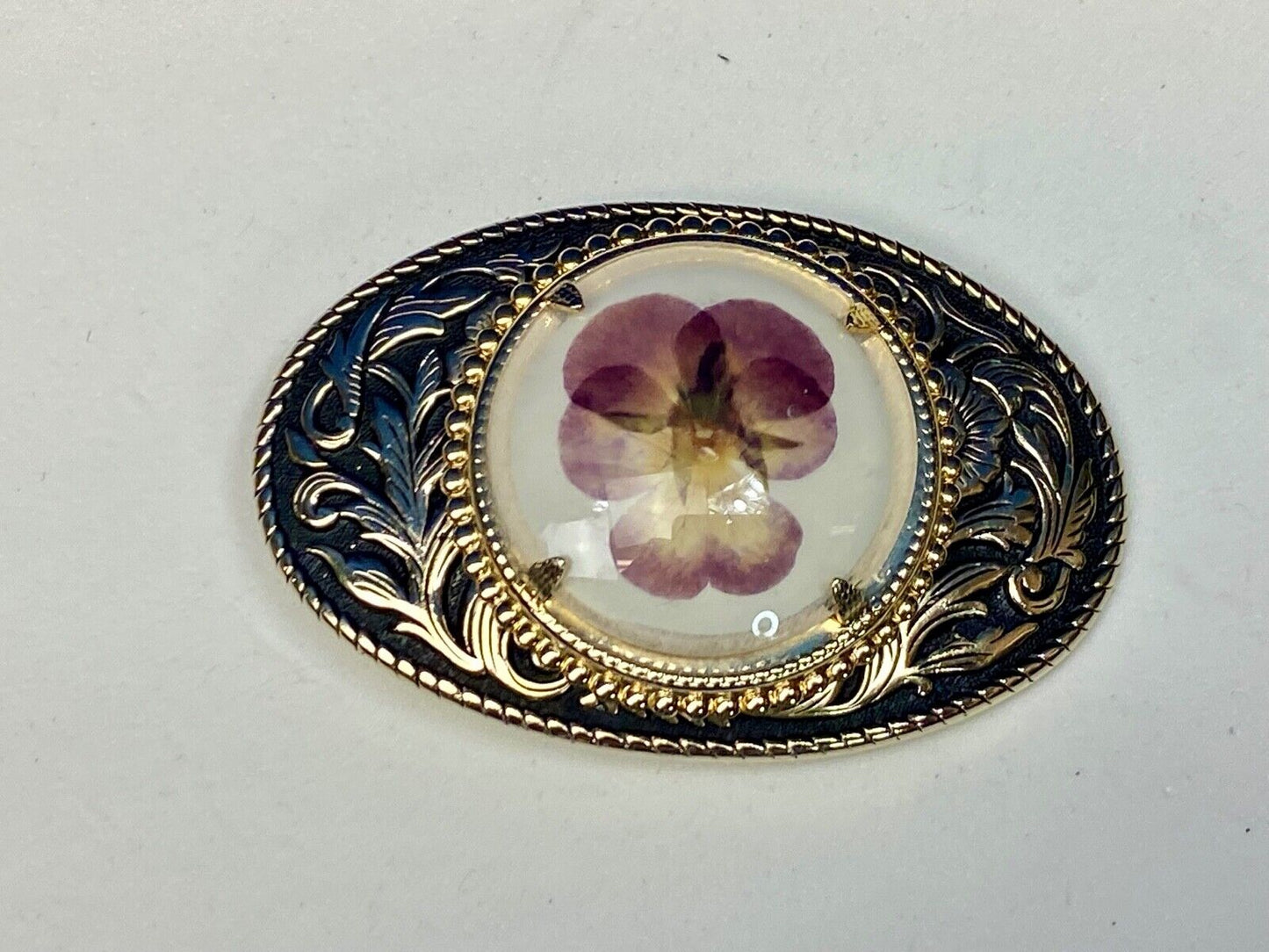 Beautiful pressed purple Violet flower as centerpiece in western belt buckle