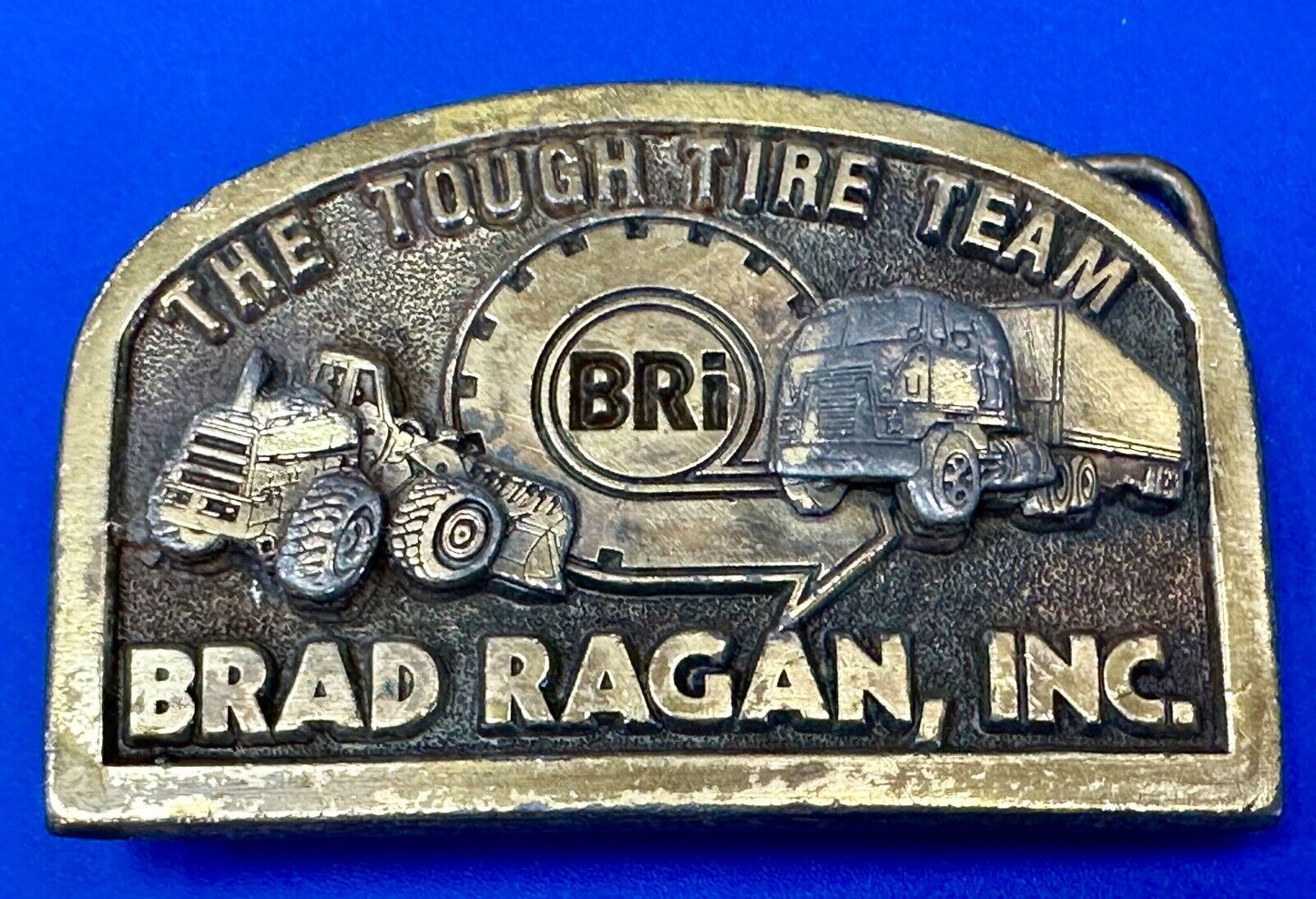 The Tough Tire Team BRi Brad Ragan, Inc. vintage belt buckle by Spec-Cast