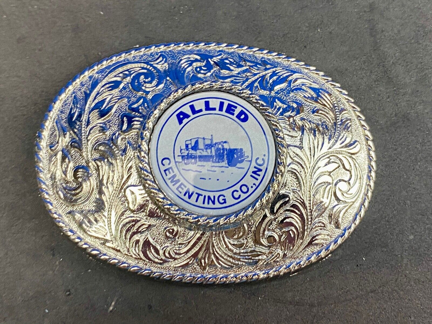 Beautiful belt buckle with centerpiece picture of Allied Cementing Company