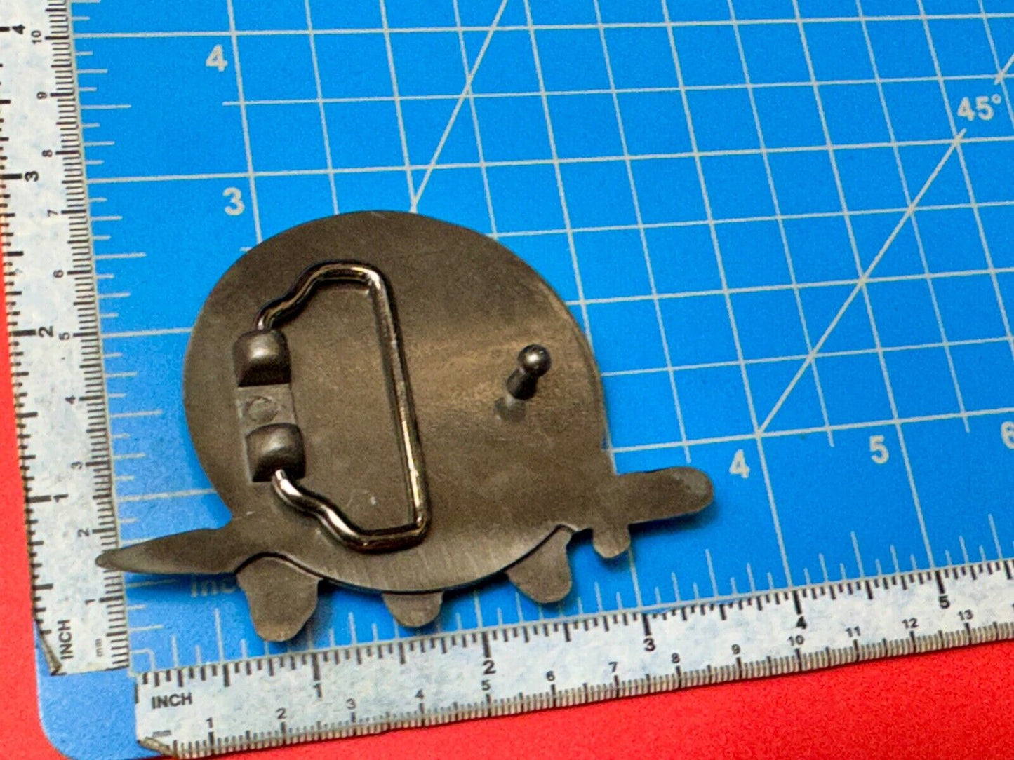 Three skulls with sword through heads on Iron Cross round NOS belt buckle