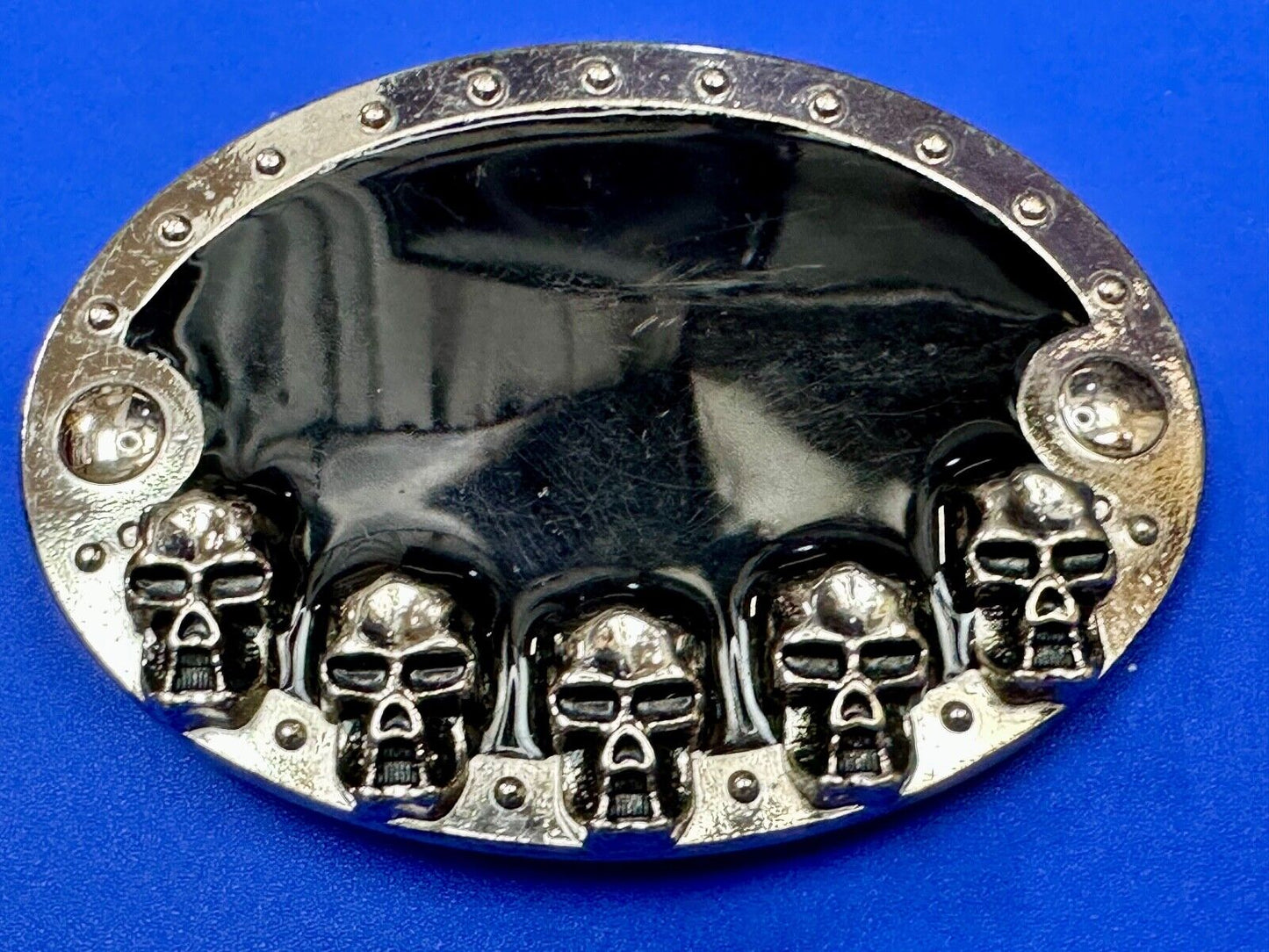 Black and silver Belt Buckle with multiple skulls on boarder
