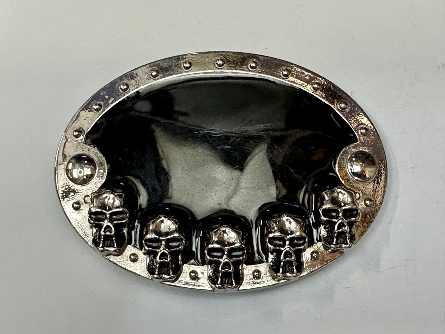 Black and silver Belt Buckle with multiple skulls on boarder