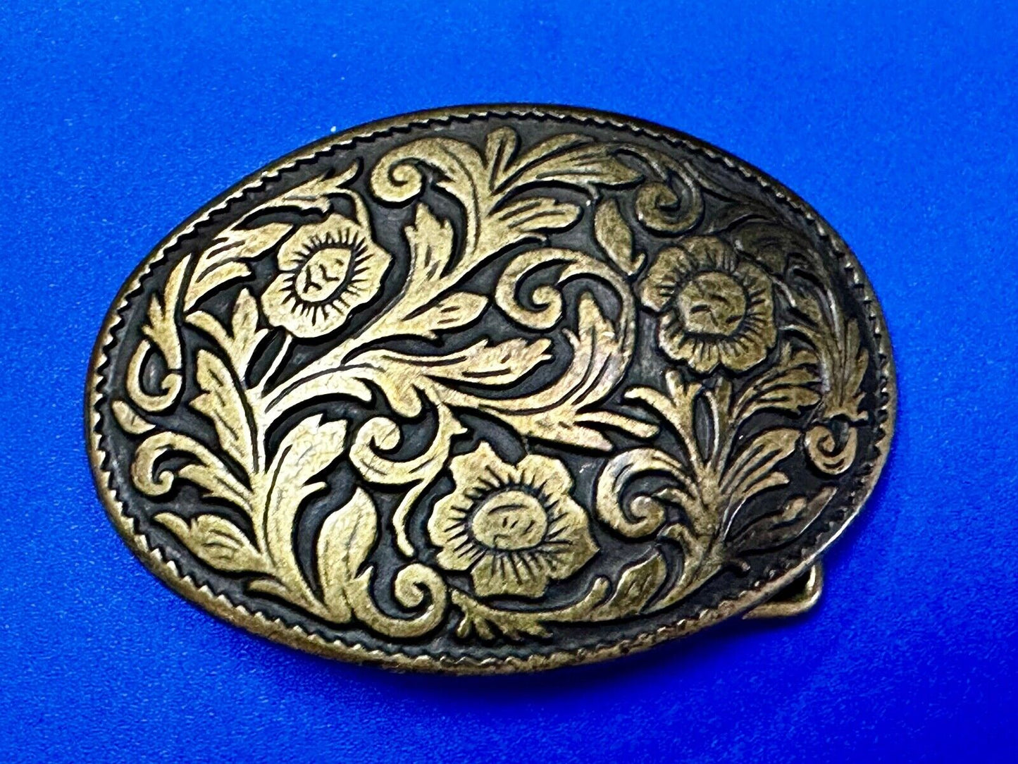 Vintage black and gold tone western flower floral theme cowboys belt buckle
