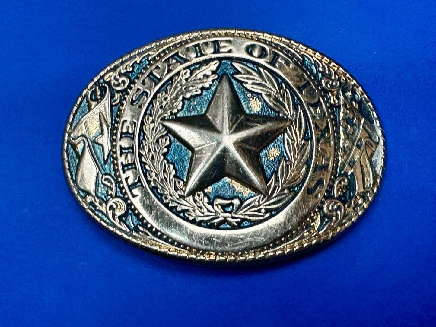 The Great State of Texas - gold color star belt buckle with blue colored accents