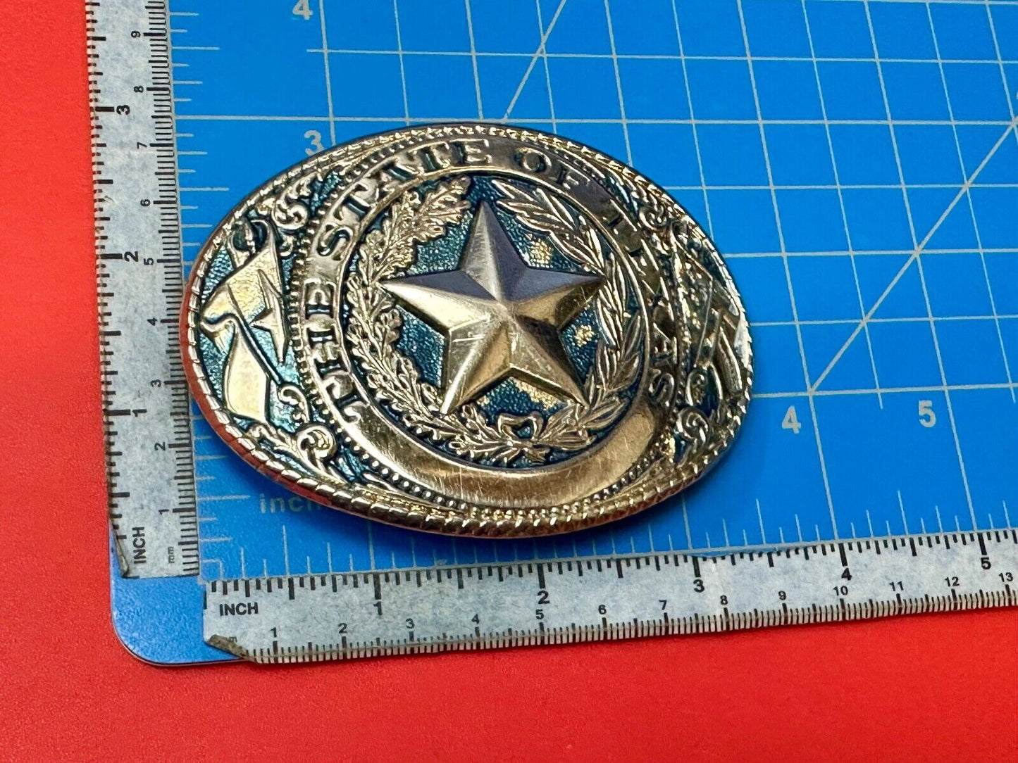 The Great State of Texas - gold color star belt buckle with blue colored accents