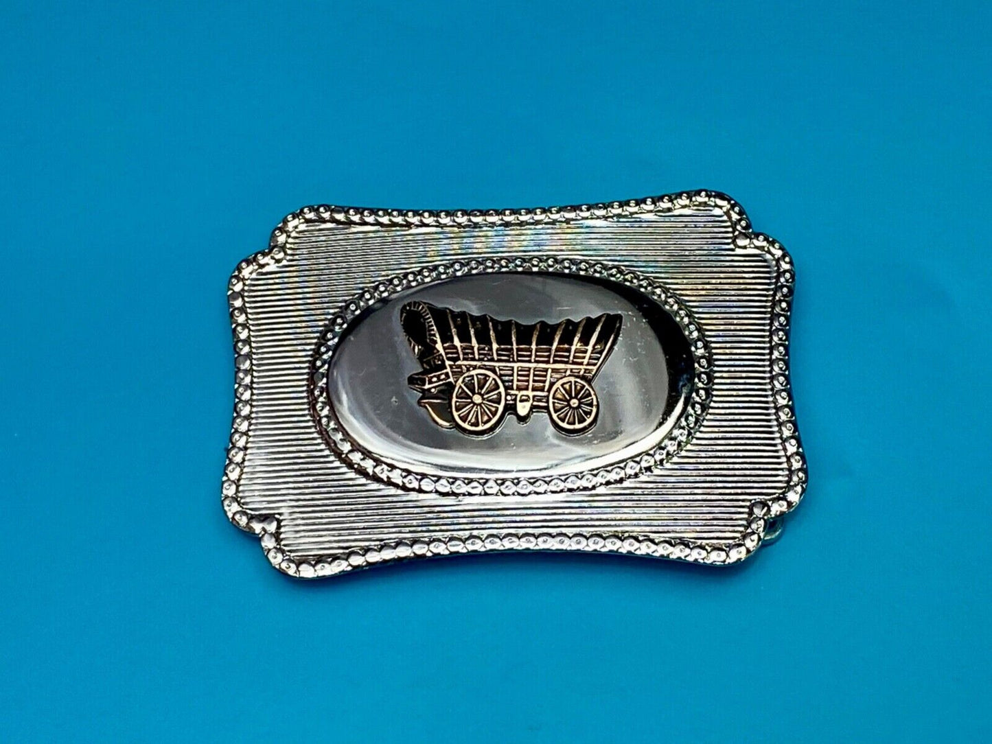 Vintage Covered wagon two tone reflective pre loved, western framed belt buckle