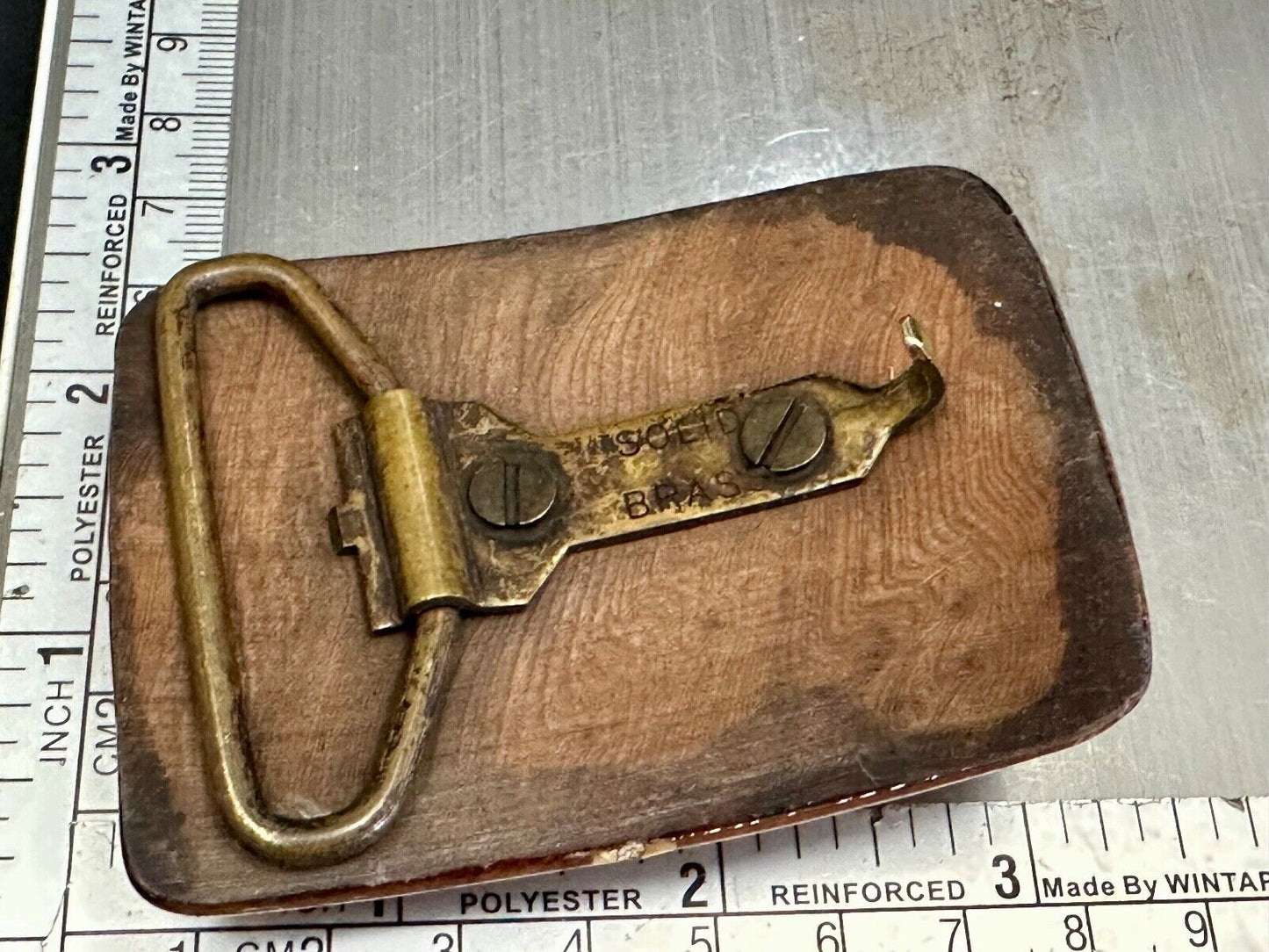 Artisan wooden glossy wood belt buckle with gold color artist scene?