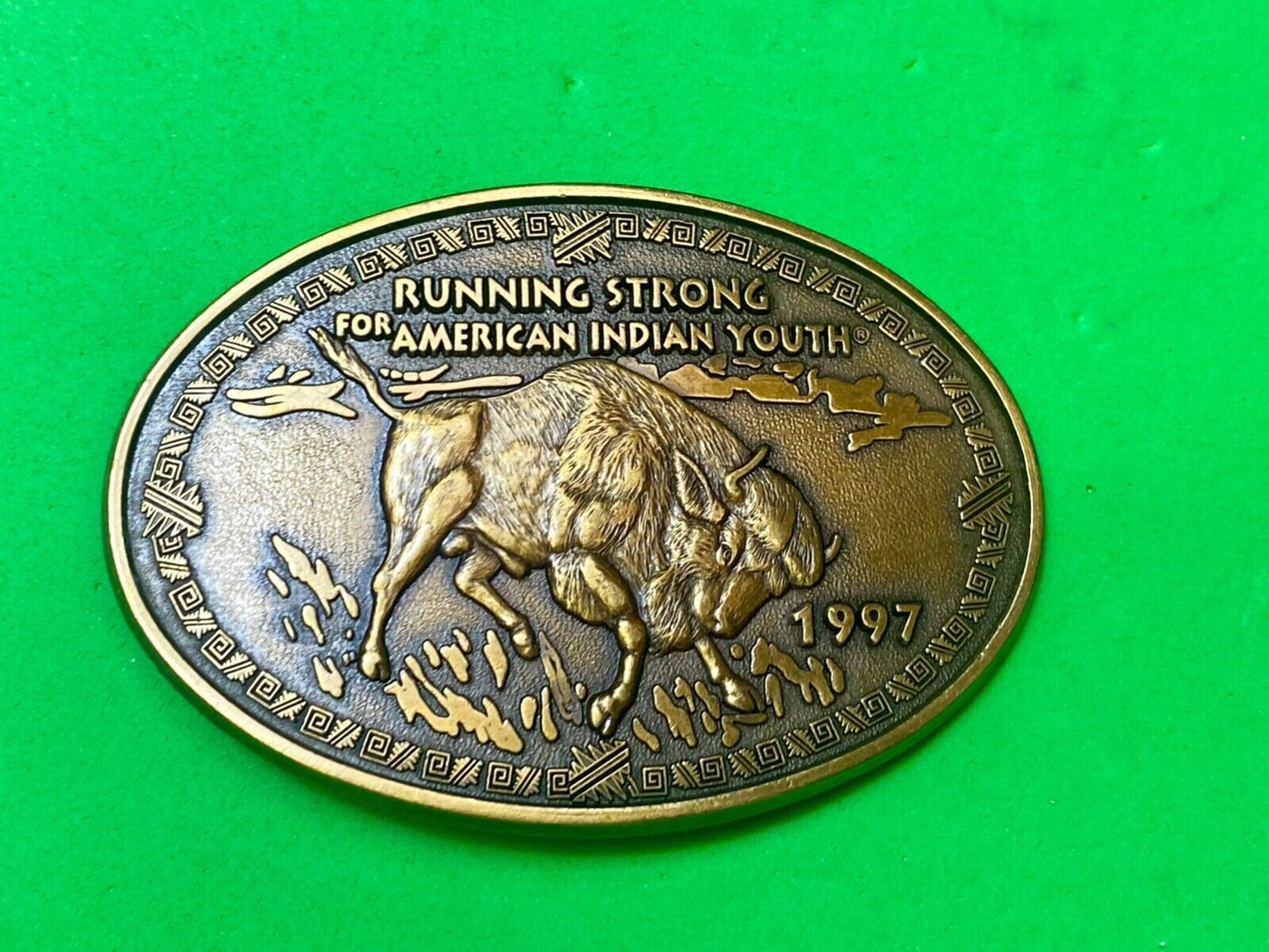 Vintage 1997 BUFFALO belt buckle RUNNING STRONG FOR AMERICAN INDIAN YOUTH
