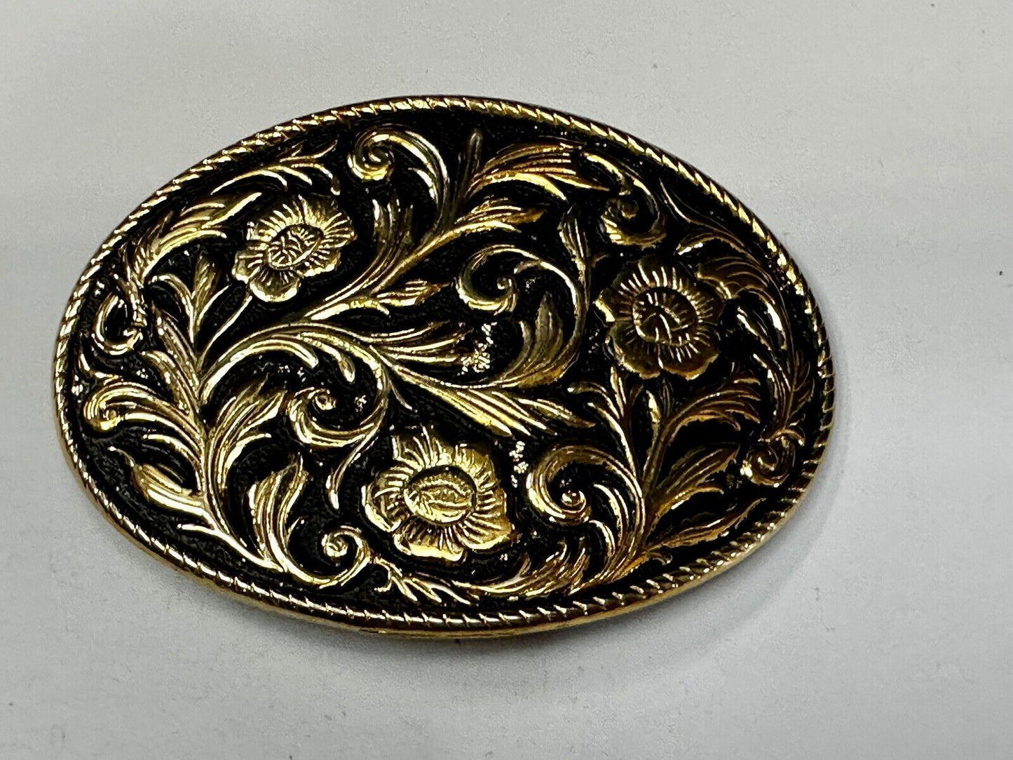 Vintage black and gold tone western flower floral theme cowboys belt buckle