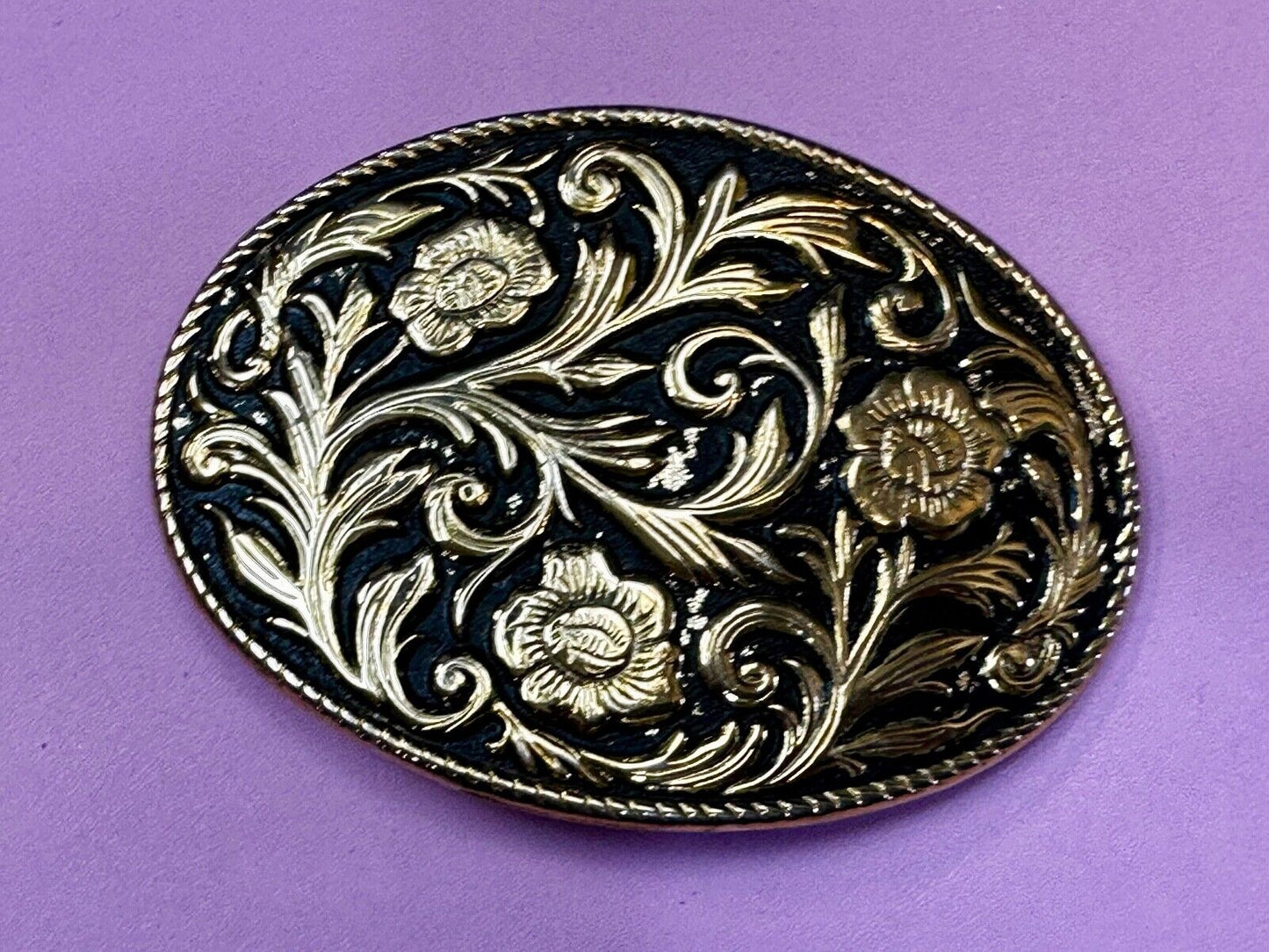 Vintage black and gold tone western flower floral theme cowboys belt buckle