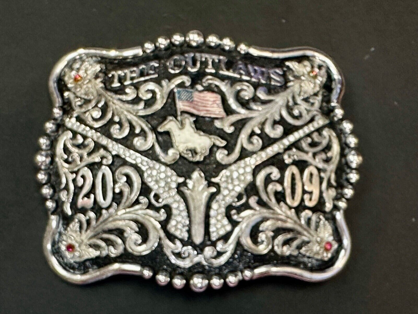 The Outlaws Rodeo Cowboy Trophy 2009 Flag Belt Buckle - Crossroads bucklesTexas
