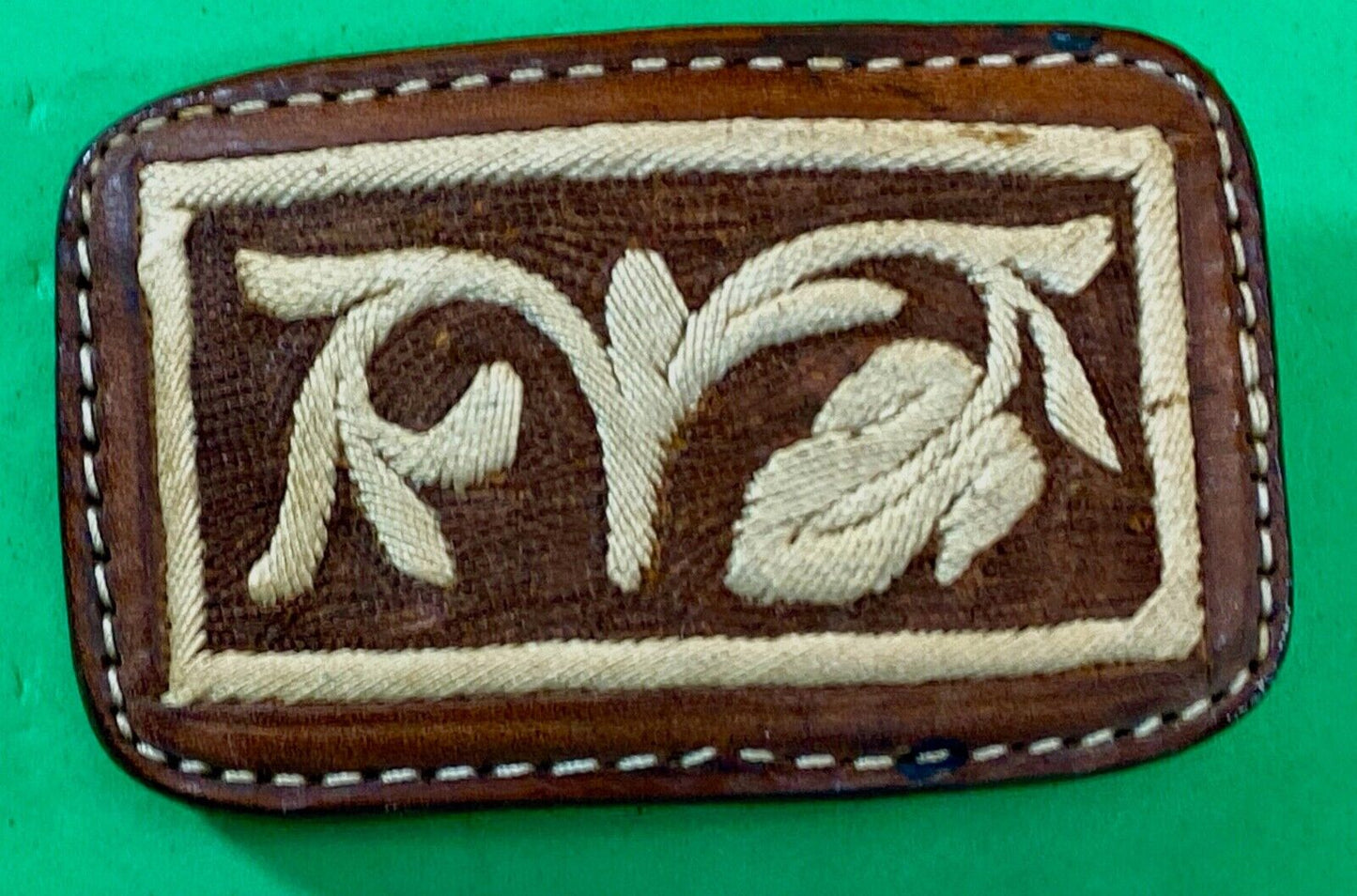 Vintage embroidered flower theme on brown leather belt buckle
