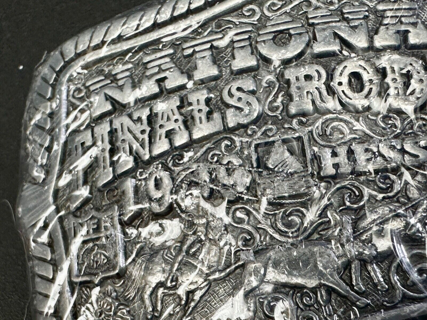 1999 Youth Sized Hesston National Finals Rodeo 2000 series belt buckle in wrap